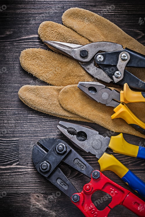 Preview: Protective Glove Steel Cutter Pliers Tin Snips On Wooden Background.