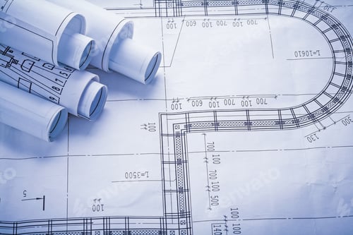 Preview: Stack Of White Rolled Blueprints With Copyspace