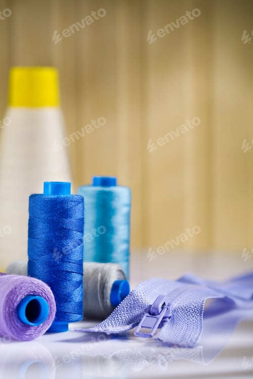 Preview: Spools And Zip On White Table