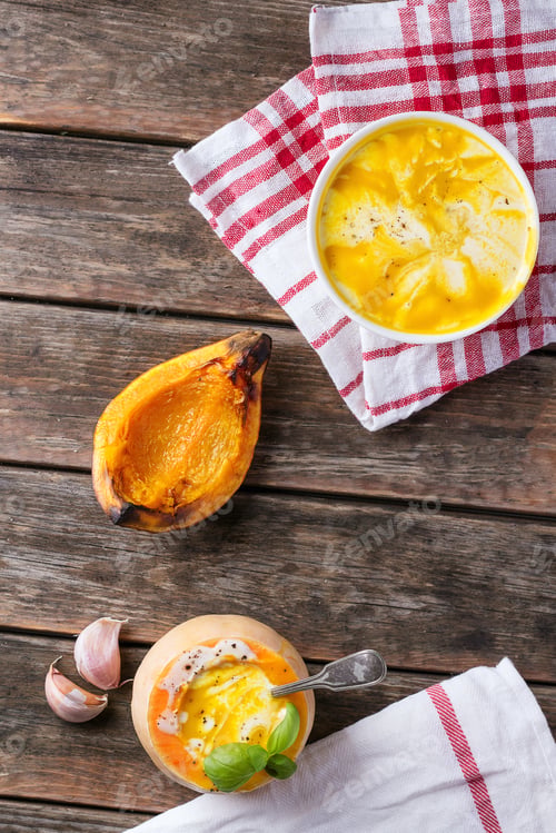 Preview: Pumpkin Soup Served With Carrot, Grilled Pumpkin Over Rustic Wooden Board. Top View. Copy Space
