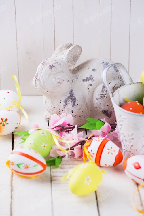 Preview: Symbols Of Spring Ester Rabbit And Decorative Eggs On White Wooden Background. Easter Background.