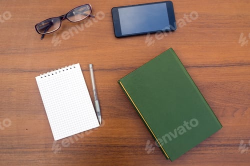 Preview: Old Book, Notepad, Pen, Eyeglasses And Smart Phone On Wooden Desk