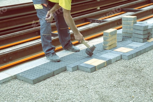 Preview: Worker Putting Down Patio Pavers On The Sidewalk During Sidewalk Reconstruction. Vintage Style.