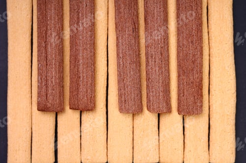 Preview: Light And Dark, Black And White Fitness Cookies With Fiber Laid Out In The Form Of Piano Keys