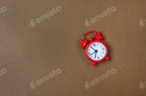 Preview: Small Red Clock On Brown Background Time Morning Concept Copy Space Top View