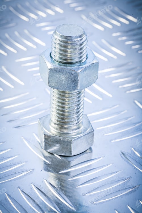 Preview: Screwbolt And Threaded Construction Nut On Corrugated Metal Background Directly Above.