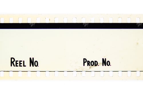 Preview: Extreme Close Up Of 35Mm Movie Film Strip With Reel And Movie Production Text Message On White