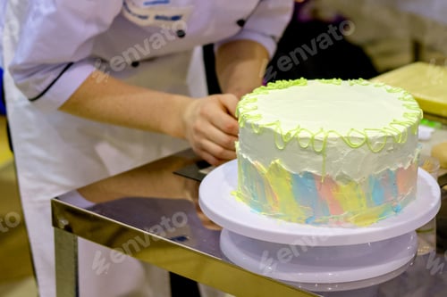 Preview: Pastry Chef Decorates A Cake In The Kitchen In A Cafe