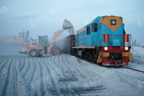 Preview: Front-End Loader Loads Crushed Stone Into Freight Railway Wagons For Transportation.