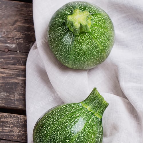 Preview: Mini Zucchinis On Rustic Wooden Board With Napkin And Knife. Top View. Square Image