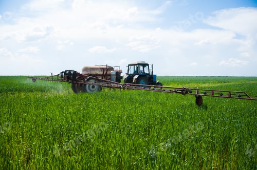 Preview: Tractor Spraying Pesticides Wheat Field With Sprayer At Spring