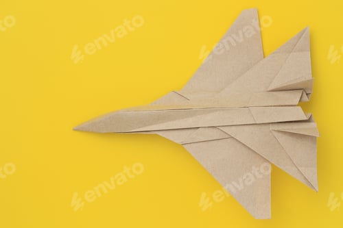 Preview: Origami Paper Airplane Mockup. Selective Focus. Bright Yellow Background