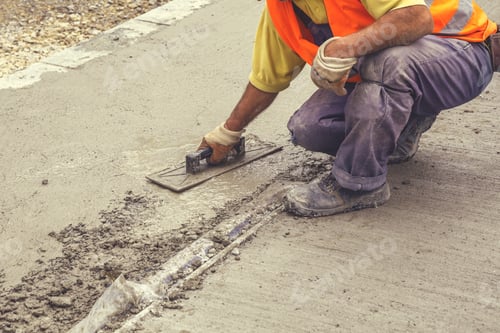 Preview: Worker Leveling Concrete With Trowel, Hands Spreading Poured Concrete. Vintage Style.