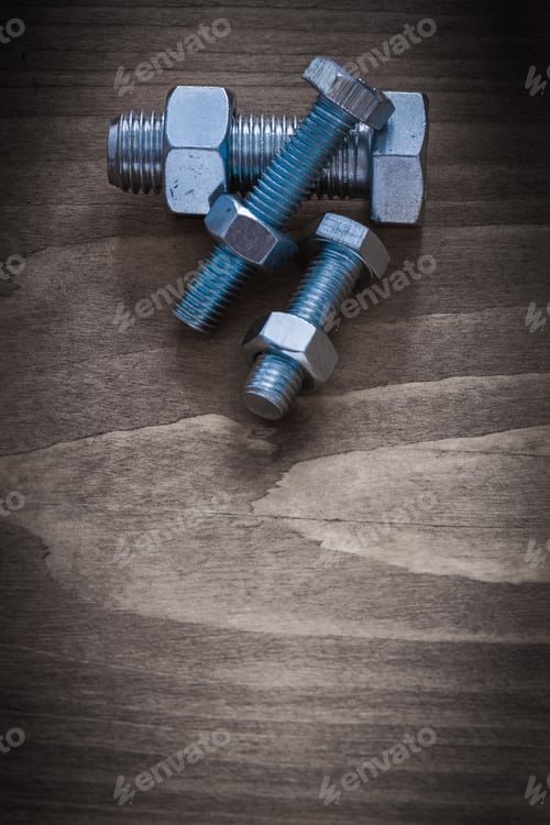 Preview: Vertical View Of Construction Nuts Screwbolts On Vintage Wood Board.