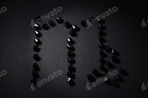 Preview: Symbol Of The Zodiac Sign Virgo Made By Black Stones On A Black Background. Low Dark Key