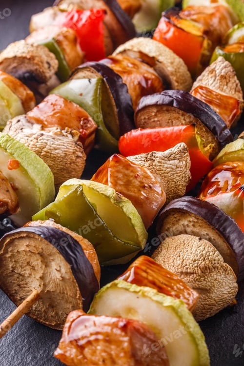 Preview: Chicken Kebabs With Vegetables And Mushrooms On A Rustic Background