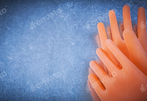 Preview: Pair Of Insulating Rubber Gloves On Metallic Background.