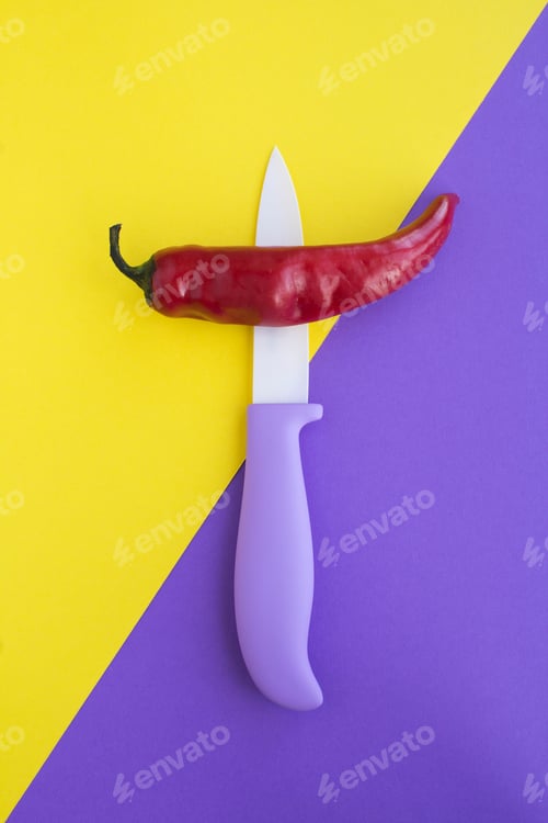 Preview: Pepper Chile And Violet Knife On The Two-Color Background. Top View. Copy Space. Vertical.
