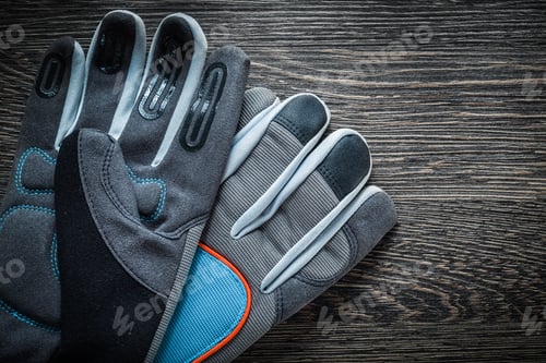 Preview: Safety Working Gloves On Vintage Wooden Board.