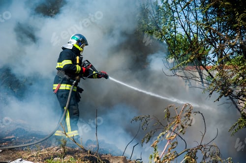 Preview: Fire In The Field Near The City. Firefighter Extinguishes A Fire