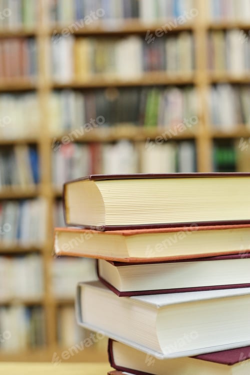 Preview: Stacked Books On A Desk In The Library