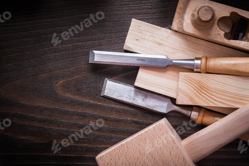 Preview: Lump Hammer Shaving Plane Flat Chisels And Wooden Bricks On Brown Board Construction Concept.