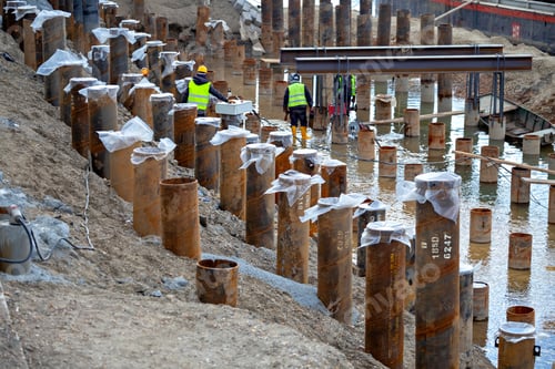 Preview: Bank Revetment Construction Site. Welder Wearing Protective Clothing And Welding Industrial