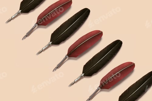 Preview: Red And Black Quill Pens Organized In A Row Over Light Background