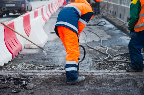 Preview: Road Worker Removes Old Asphalt With A Jackhammer During Road Construction