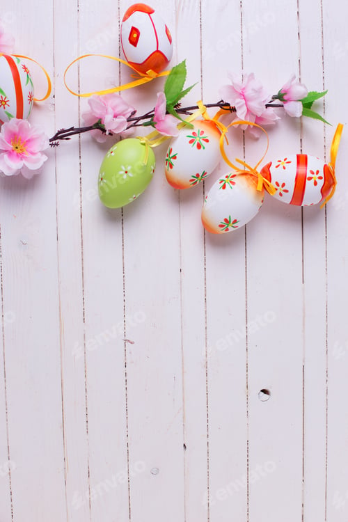 Preview: Colorful Easter Eggs On White Painted Wooden Planks With Place For Text. Easter Background.
