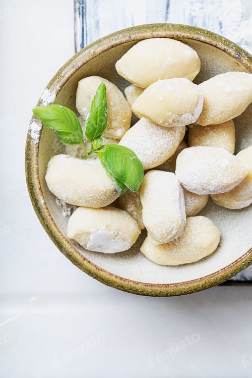Preview: Traditional Italian Potato Gnocci (Pasta) Decorated With Basil Leaf, Eggs, Flour. Uncooked Pasta