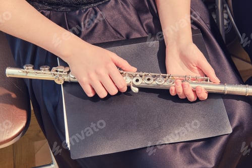 Preview: Young Woman Holding A Flute In Her Hands, Close-Up