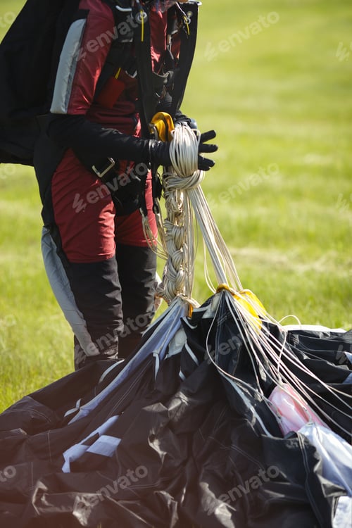 Preview: Girl Skydiver Weaves A Pigtail From A Slings After Landing With A Parachute, Face Is Not Visible.