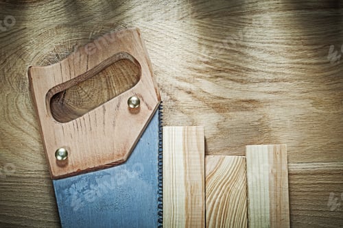 Preview: Hacksaw Timber On Wood Board Construction Concept.