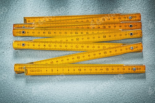 Preview: Yellow Wooden Meter On Concrete Surface Construction Concept.