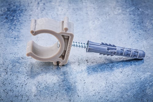 Preview: Plastic Pipe Clamp On Metallic Background Horizontal Image Construction Concept.