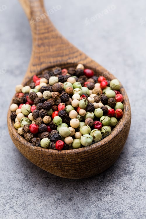 Preview: Peppercorn Mix In A Wooden Bowl On Grey Table.