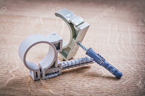 Preview: Plastic Fixators For Pipes On Wooden Board