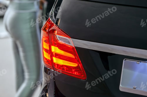 Preview: Closeup Red Tail Light On Black Car; Note Shallow Depth Of Field