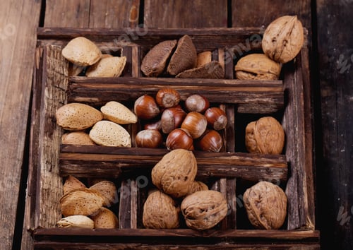 Preview: Various Nuts On The Rustic Wooden Board: Almonds, Walnuts And Hazelnuts