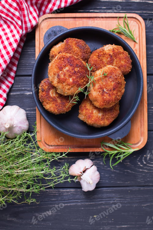 Preview: Homemade Cutlets With Herb And Spices On Black Wooden Background. Selective Focus. Vertical Image.