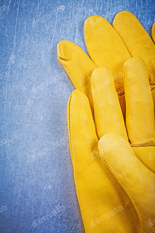 Preview: Leather Protective Gloves On Metallic Background Electricity Concept.