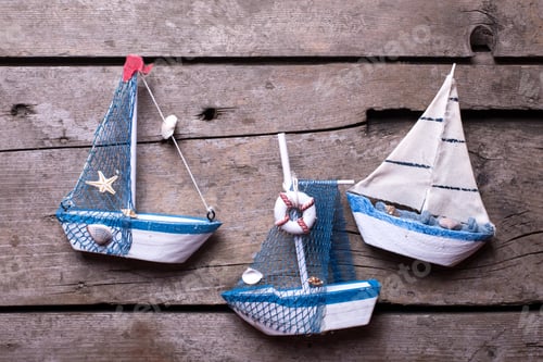 Preview: Decorative Sailing Boats On Aged Wooden Background. Vacation Background. Selective Focus.