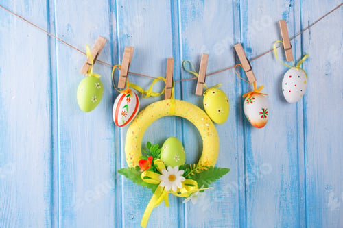 Preview: Colorful Easter Eggs On Rope On Blue Wooden Background. Easter Background.