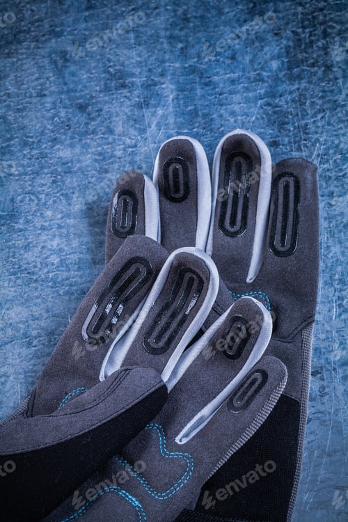 Preview: Pair Of Fabric Protective Gloves On Scratched Metallic Background.