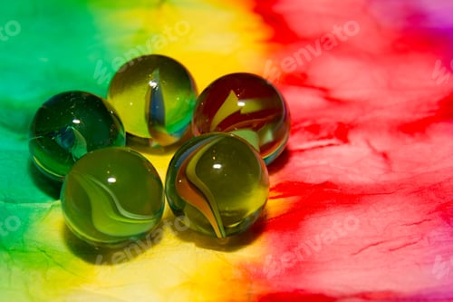 Preview: Colorful Glass Beads On Batik Background.