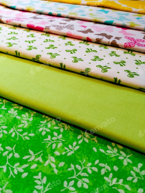 Preview: Colorful Patterned Fabric Stacked in a Textile Display