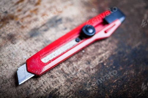 Preview: Color Image Of A Utility Knife On A Wooden Plank.