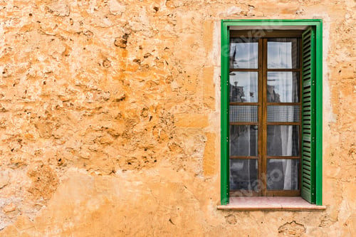 Preview: Mediterranean House With Rustic Stone Wall Background And Open Green Window Shutters.