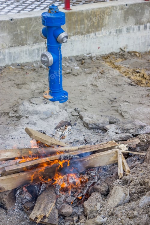 Preview: Fire Hydrant And Bonfire On Construction Site. Workers Chopped Old Pallets Into Bonfire On A Cold